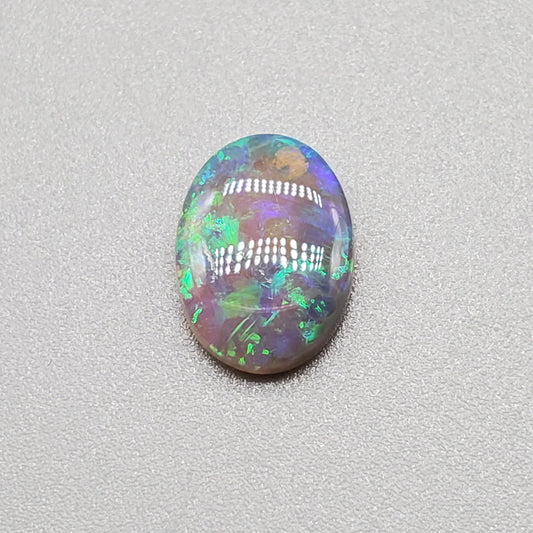 1.3cts  Semi Black Opal with Green-Blue mixed patterns and a translucent dark base