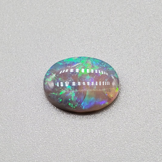 1.3cts  Semi Black Opal with Green-Blue mixed patterns and a translucent dark base