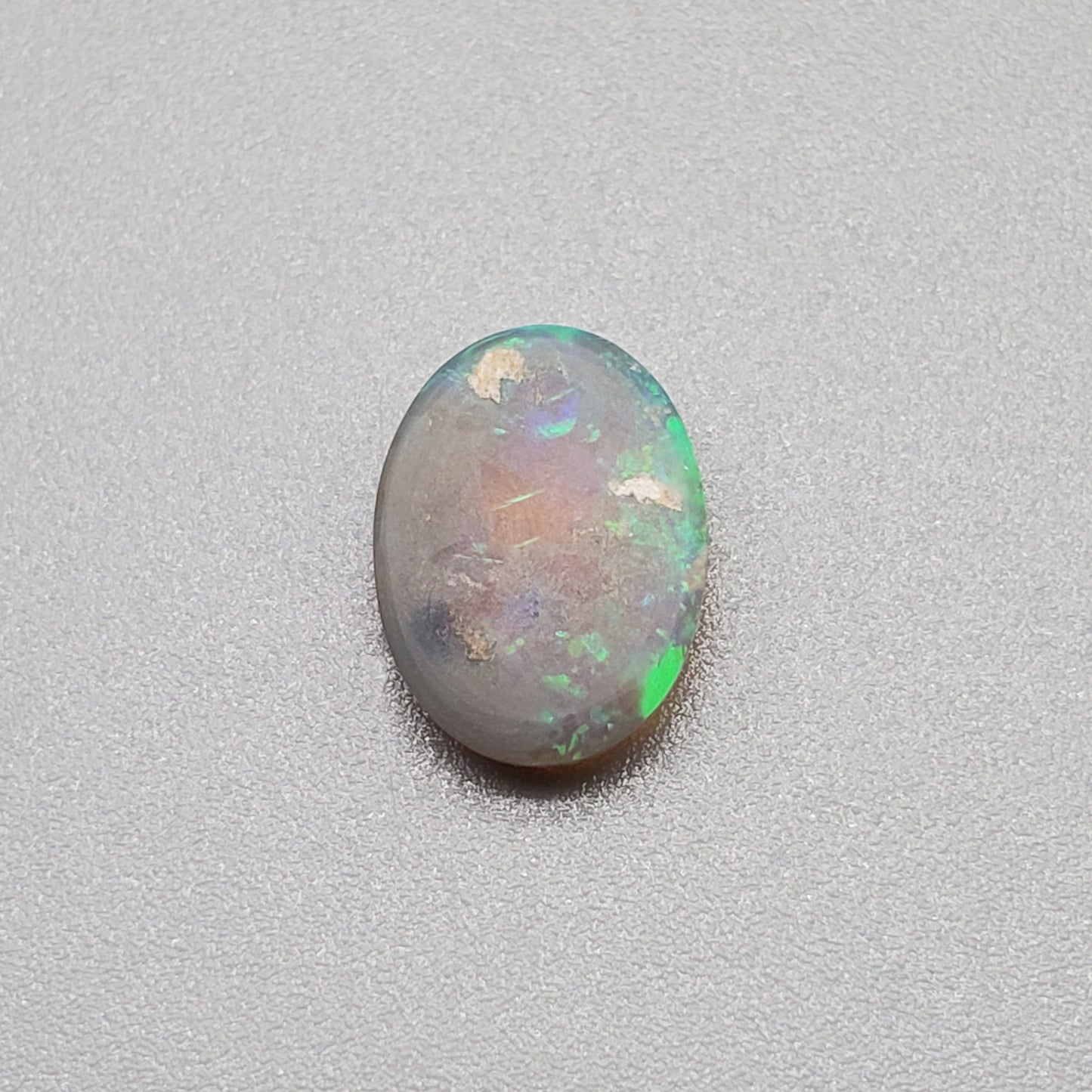 1.3cts  Semi Black Opal with Green-Blue mixed patterns and a translucent dark base