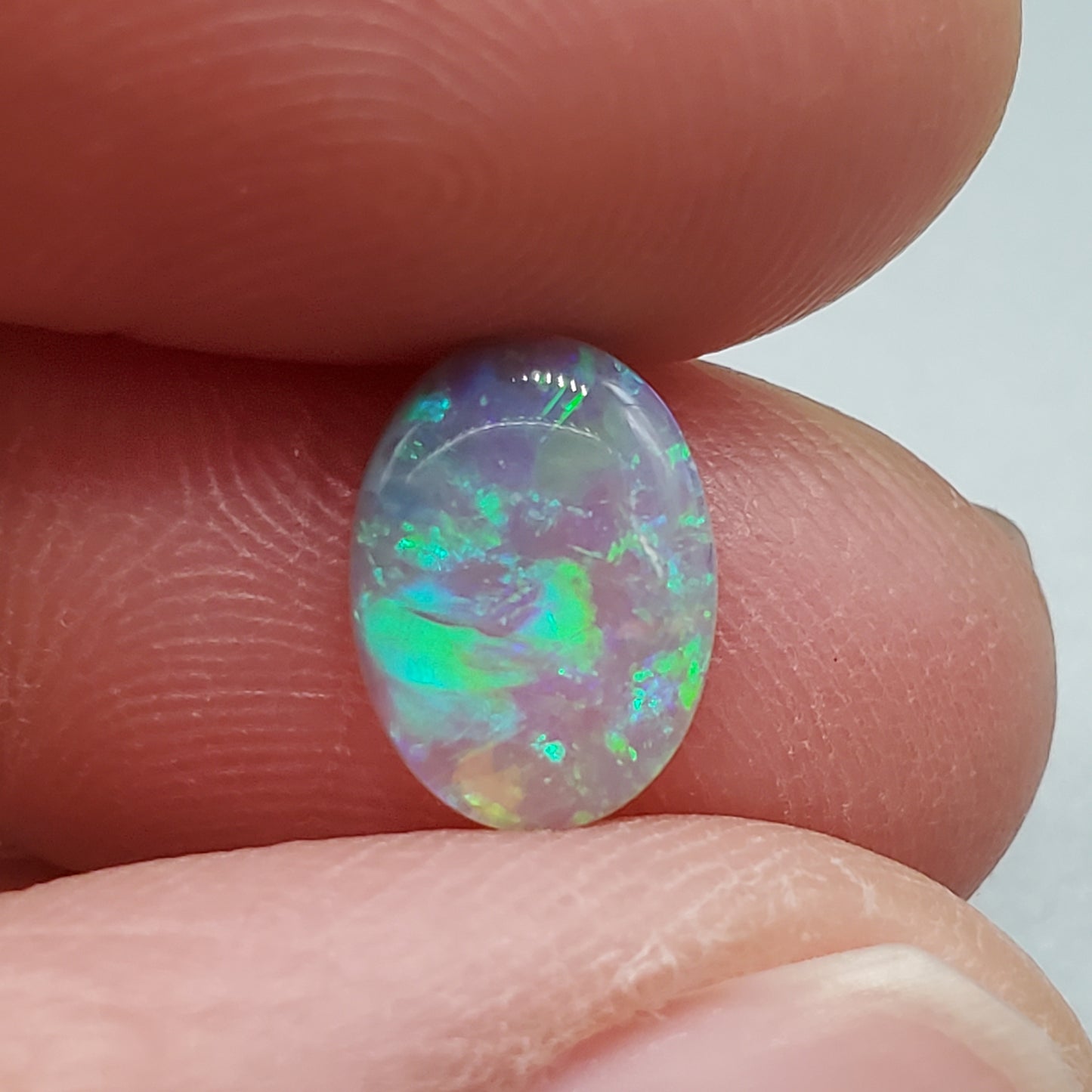 1.3cts  Semi Black Opal with Green-Blue mixed patterns and a translucent dark base