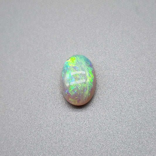 1.7cts Dark opal with a springtime pallet of yellows, greens and light blue