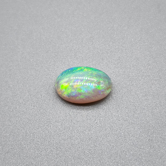 1.7cts Dark opal with a springtime pallet of yellows, greens and light blue