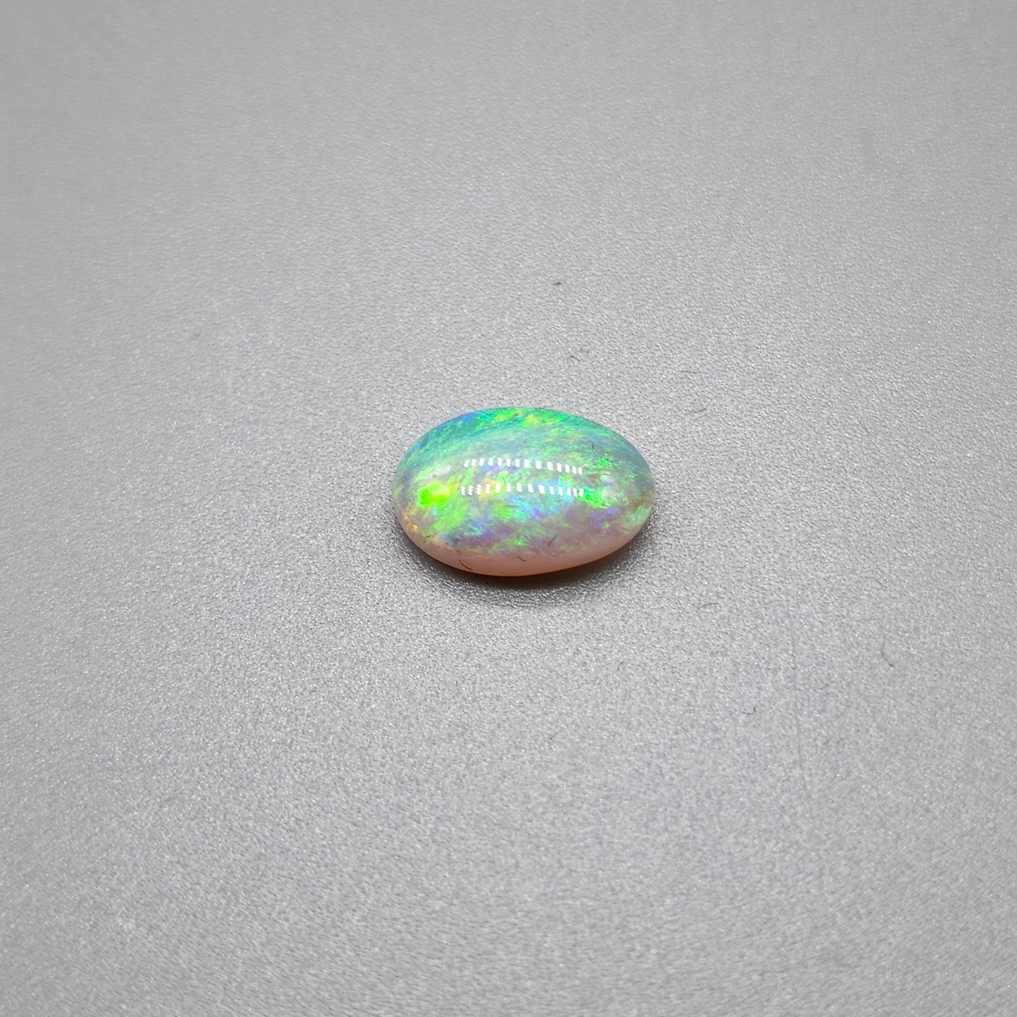 1.7cts Dark opal with a springtime pallet of yellows, greens and light blue