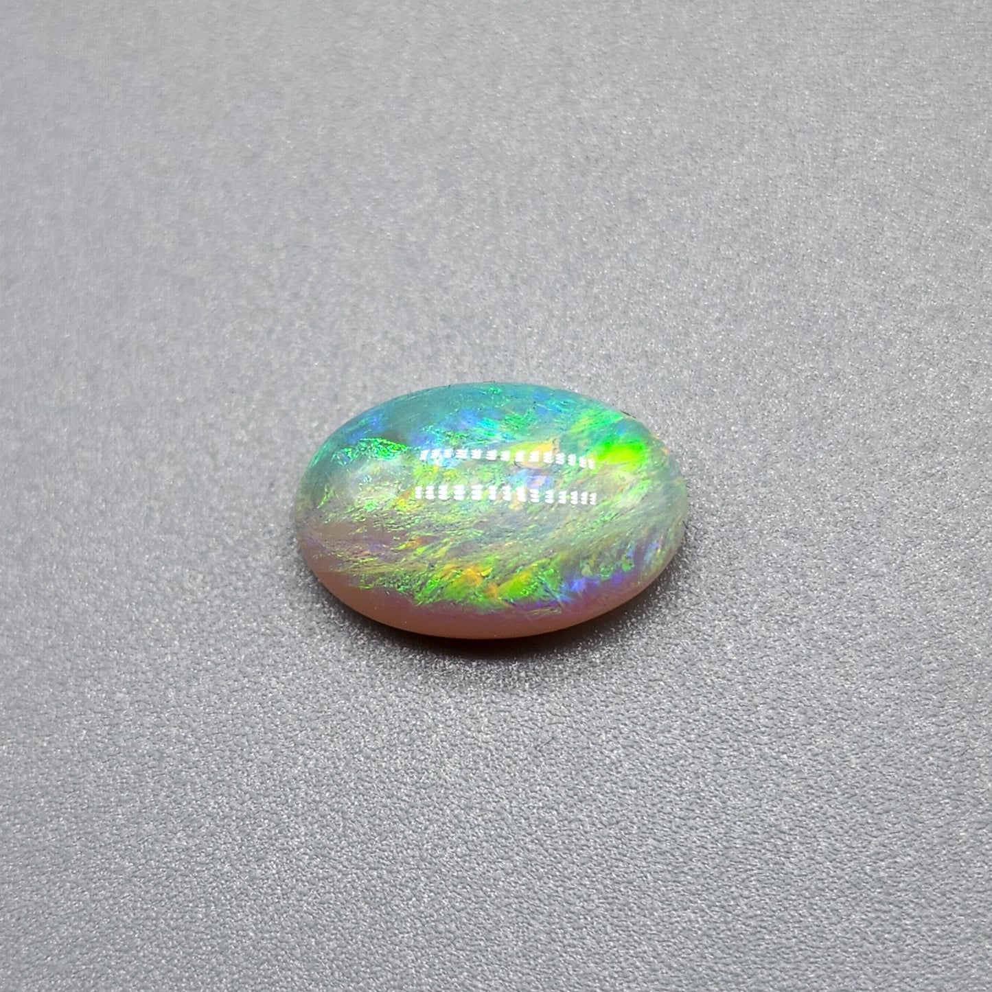 1.7cts Dark opal with a springtime pallet of yellows, greens and light blue