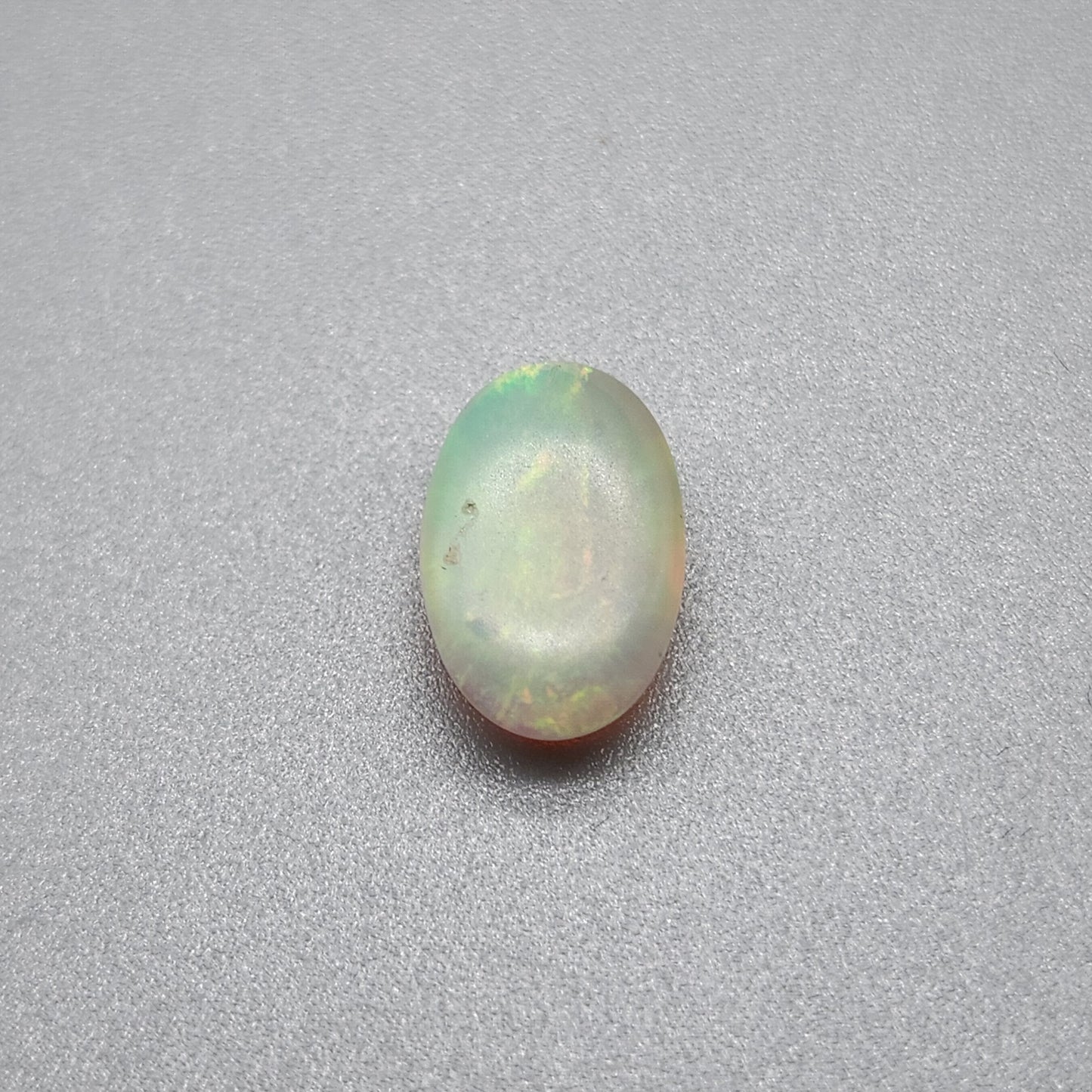 1.7cts Dark opal with a springtime pallet of yellows, greens and light blue