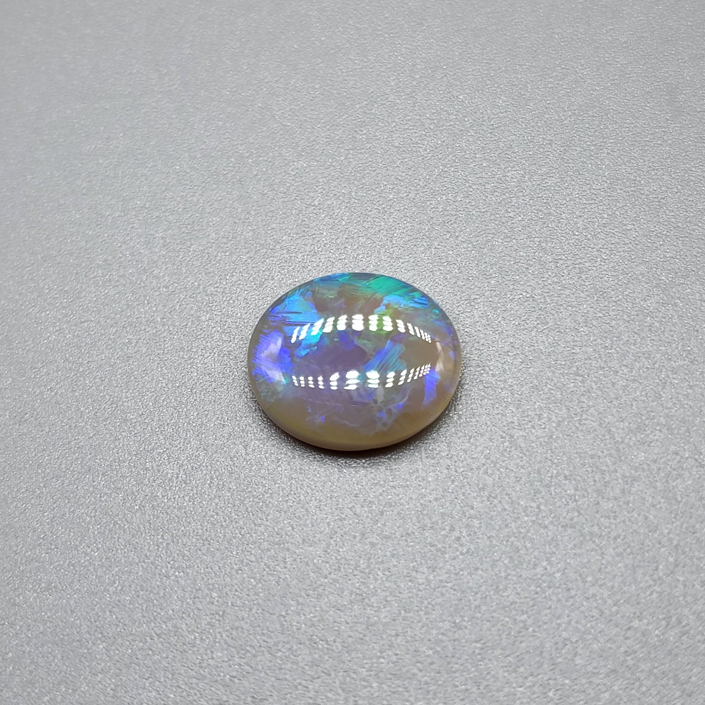 1.8cts Dark opal with blue green color play and blocky pattern with chaff