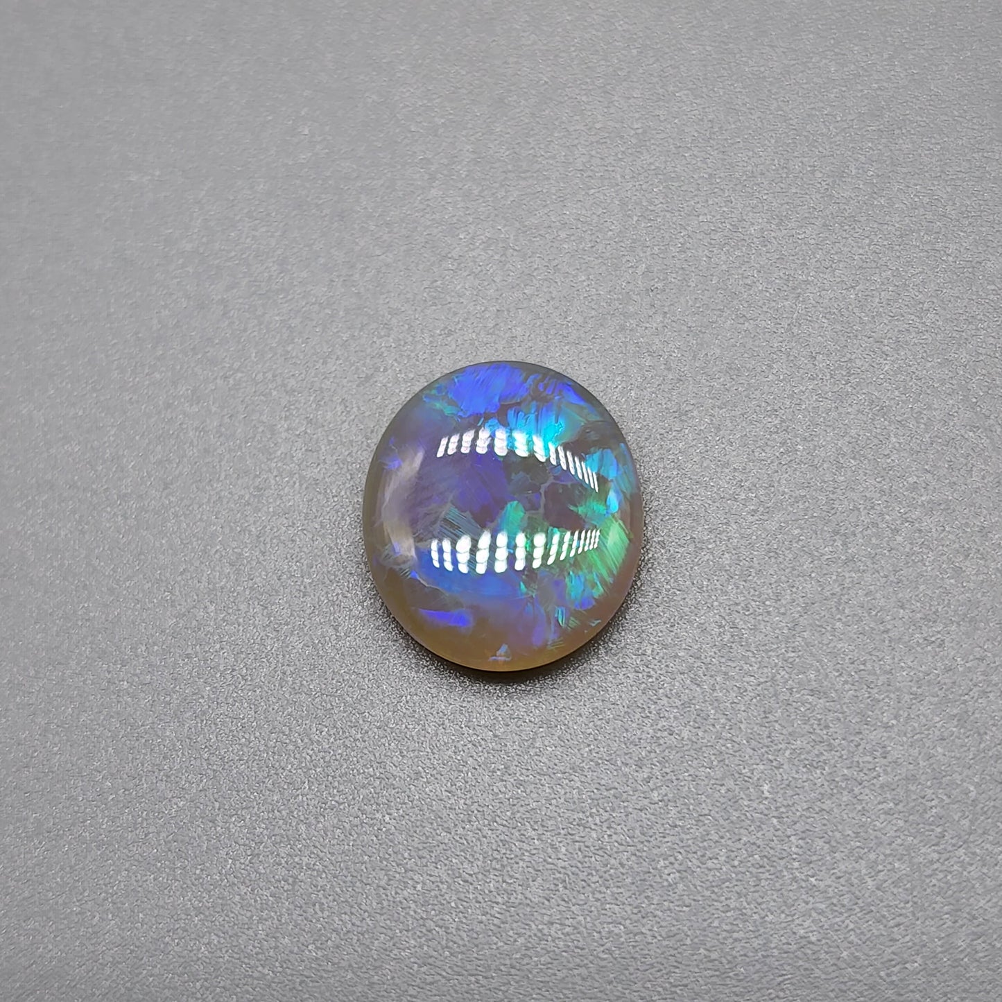 1.8cts Dark opal with blue green color play and blocky pattern with chaff