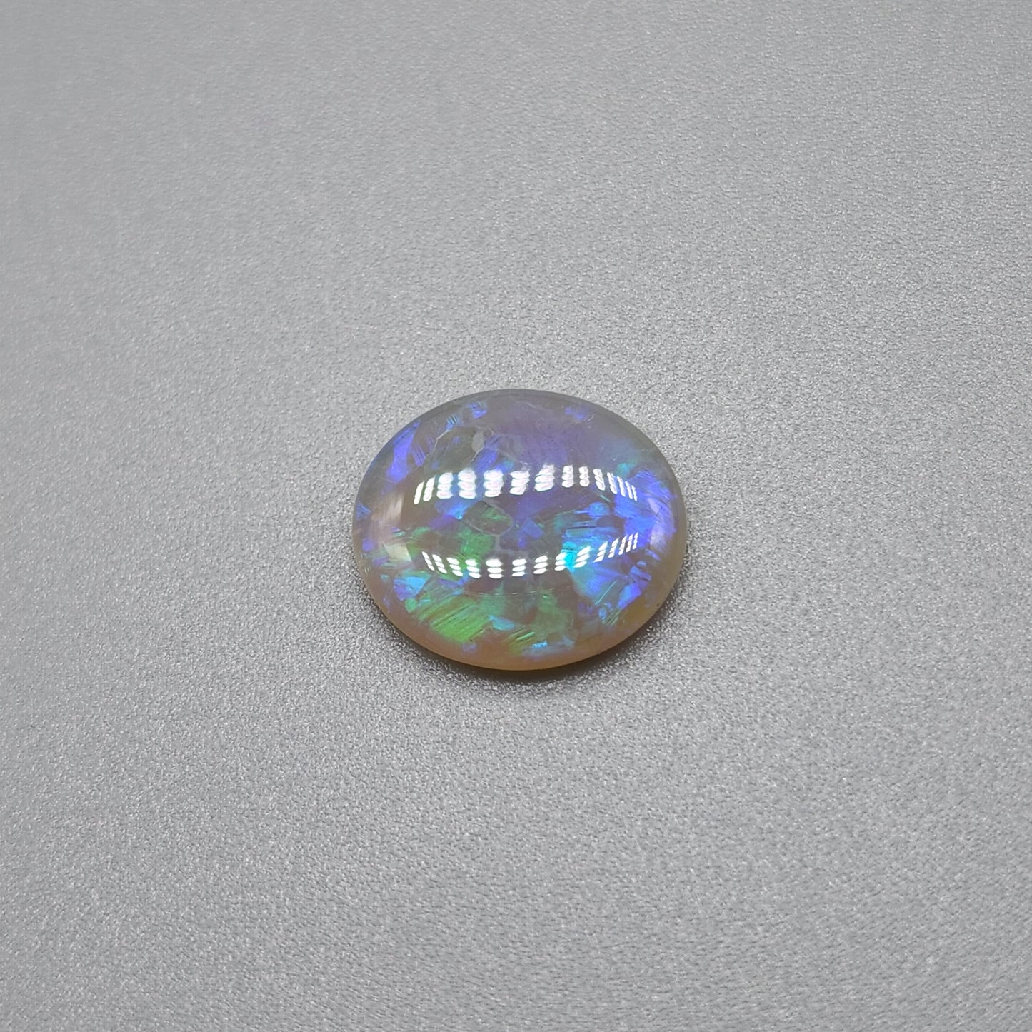 1.8cts Dark opal with blue green color play and blocky pattern with chaff