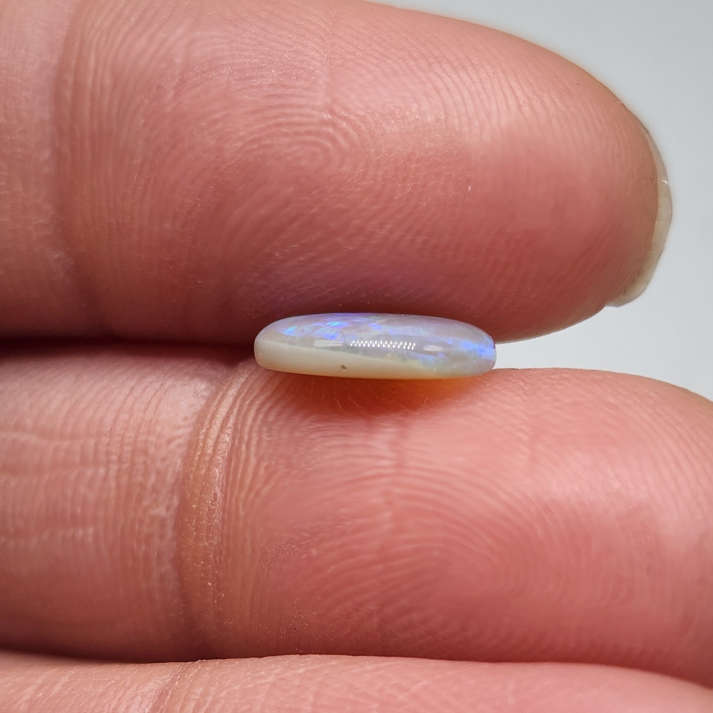 1.8cts Dark opal with blue green color play and blocky pattern with chaff