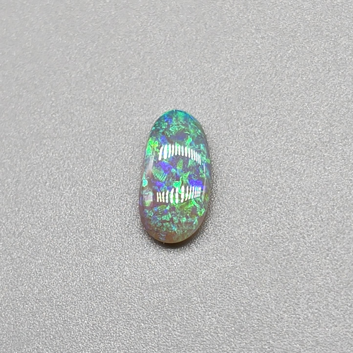 0.9ct freeform Dark Opal with aesthetic Green/blue pattern