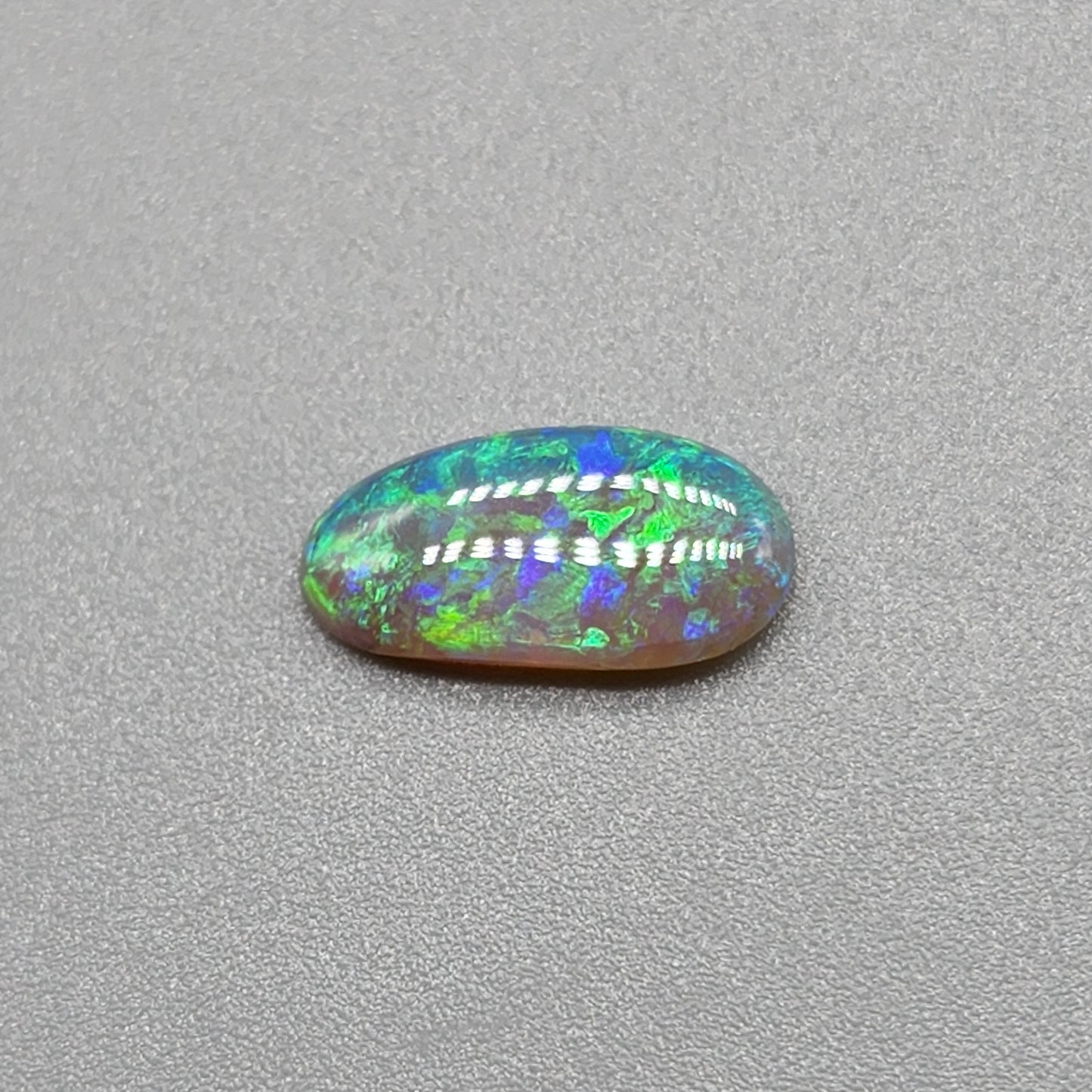 0.9ct freeform Dark Opal with aesthetic Green/blue pattern