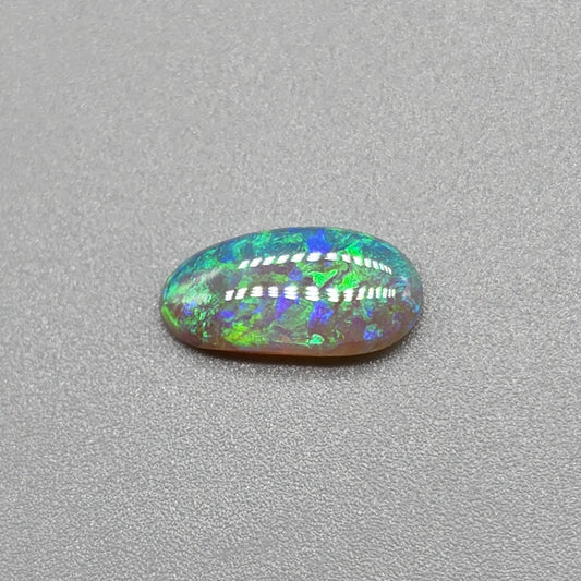 0.9ct freeform Dark Opal with aesthetic Green/blue pattern