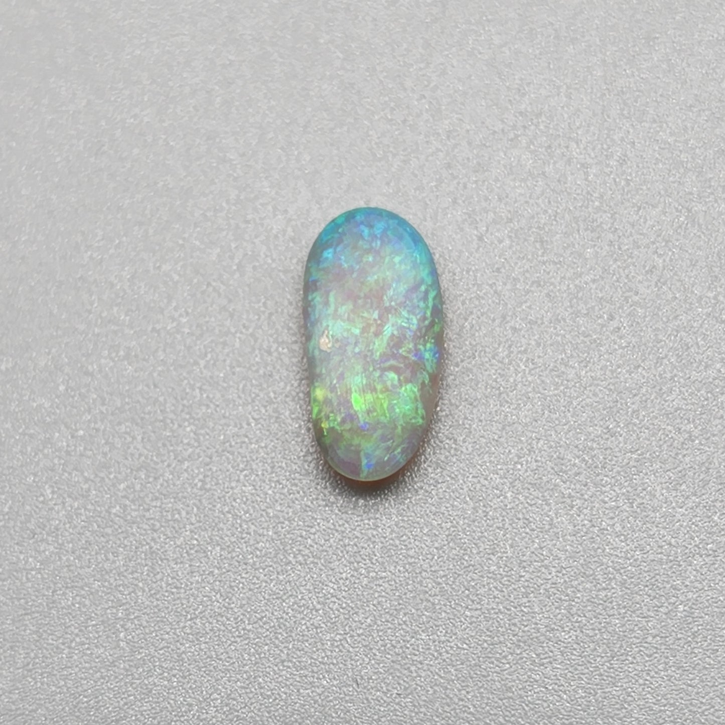 0.9ct freeform Dark Opal with aesthetic Green/blue pattern