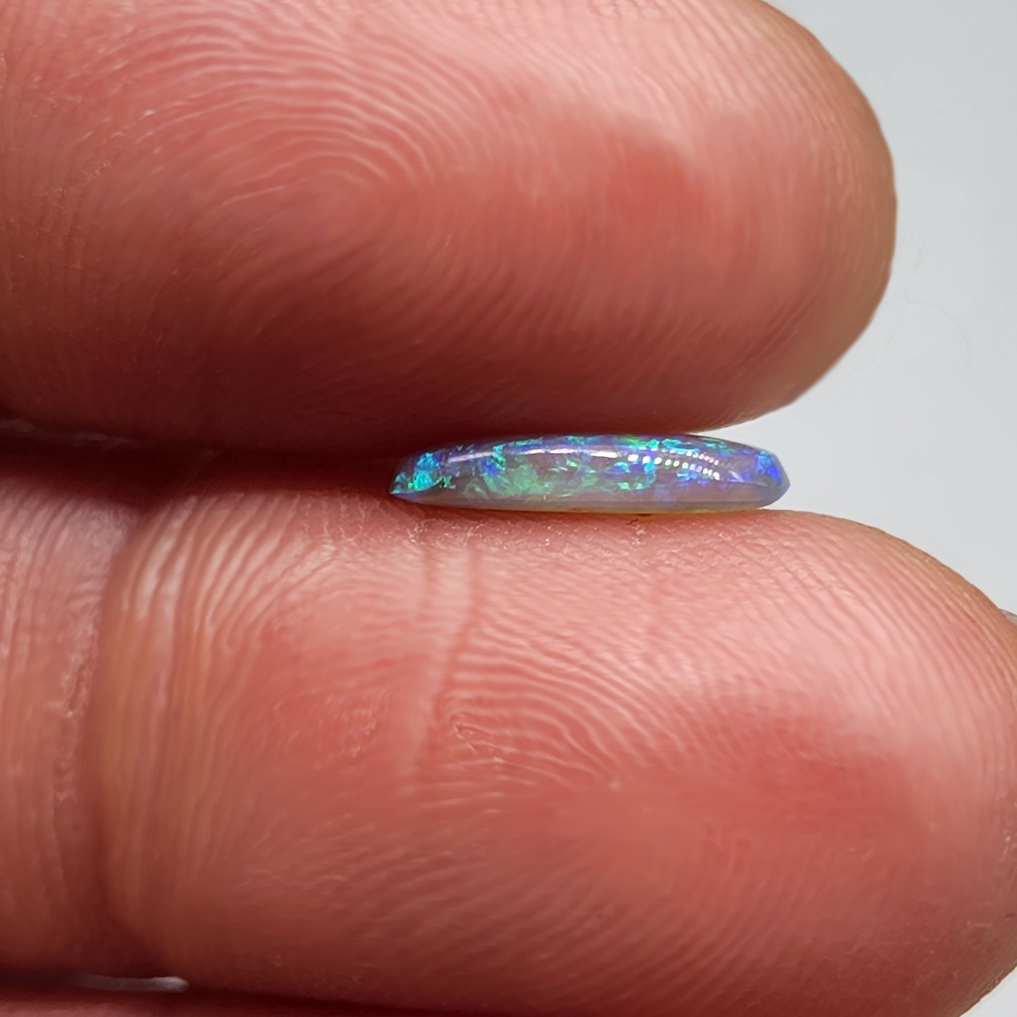 0.9ct freeform Dark Opal with aesthetic Green/blue pattern