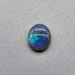 2.5ct Dark opal with a a dark blue base overlane by a minty green chaff pattern