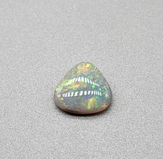 1.5cts  Dark opal with yellow, green, orange color play and mixed pattern