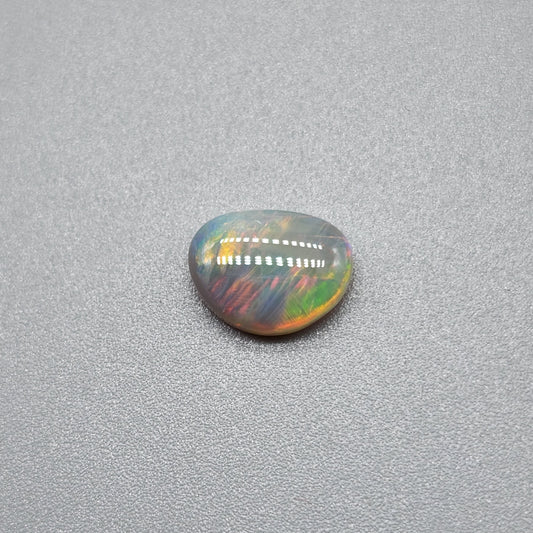 1cts Dark opal with a fiery color pallet and a feathery broad flash pattern