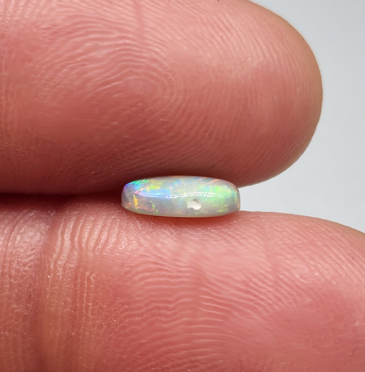 1cts Dark opal with a fiery color pallet and a feathery broad flash pattern