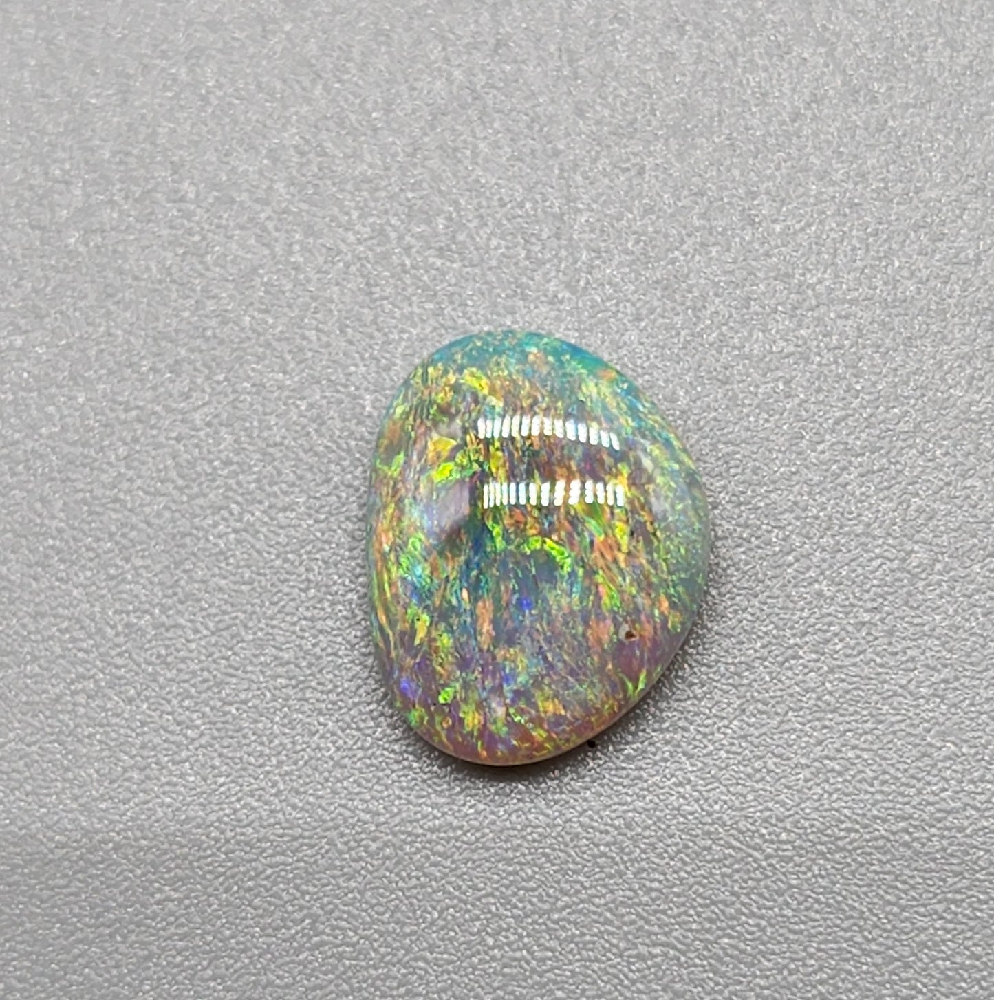 1.2cts Dark opal with a multi color pallet and feathery small flash pattern