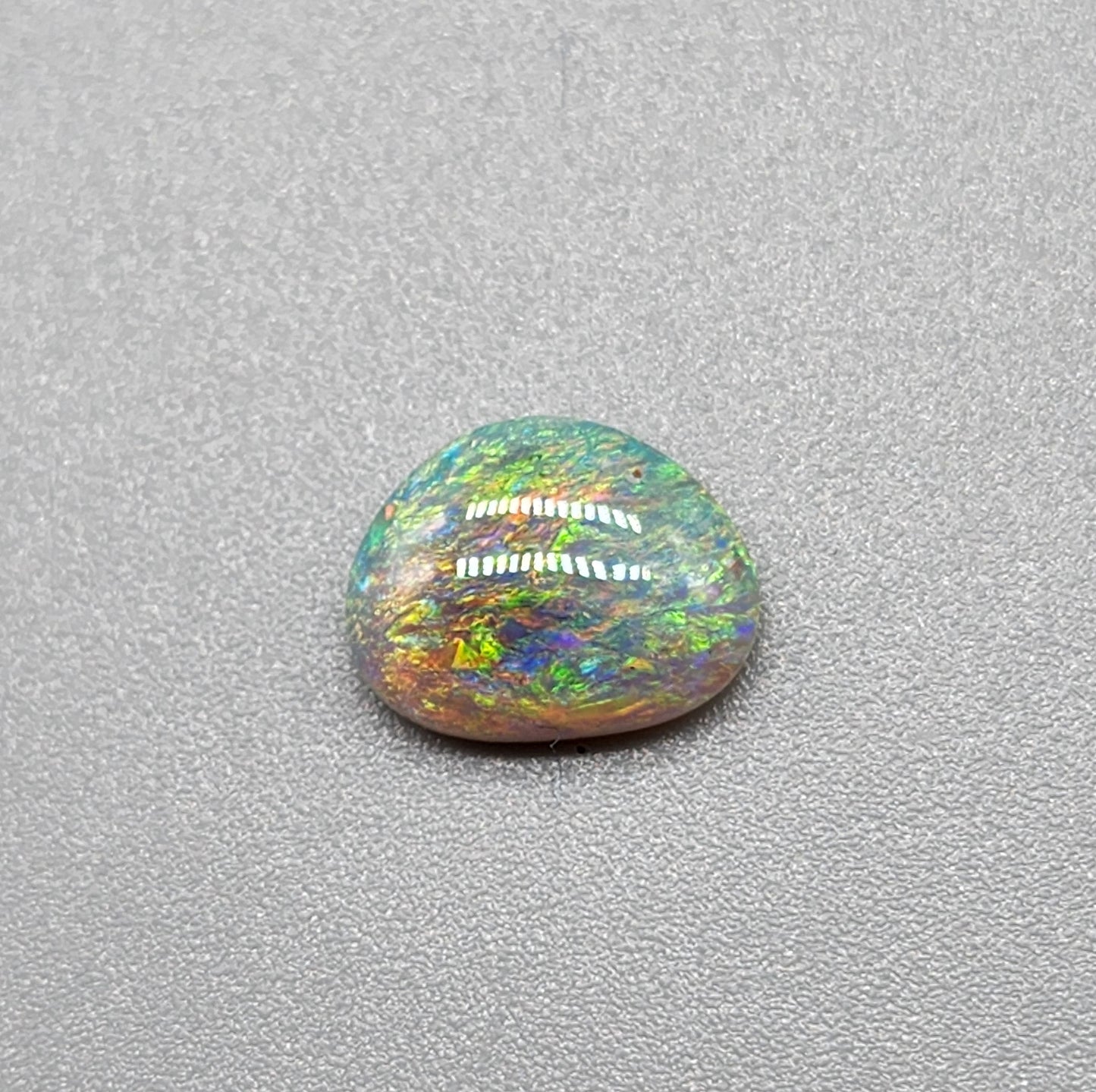 1.2cts Dark opal with a multi color pallet and feathery small flash pattern