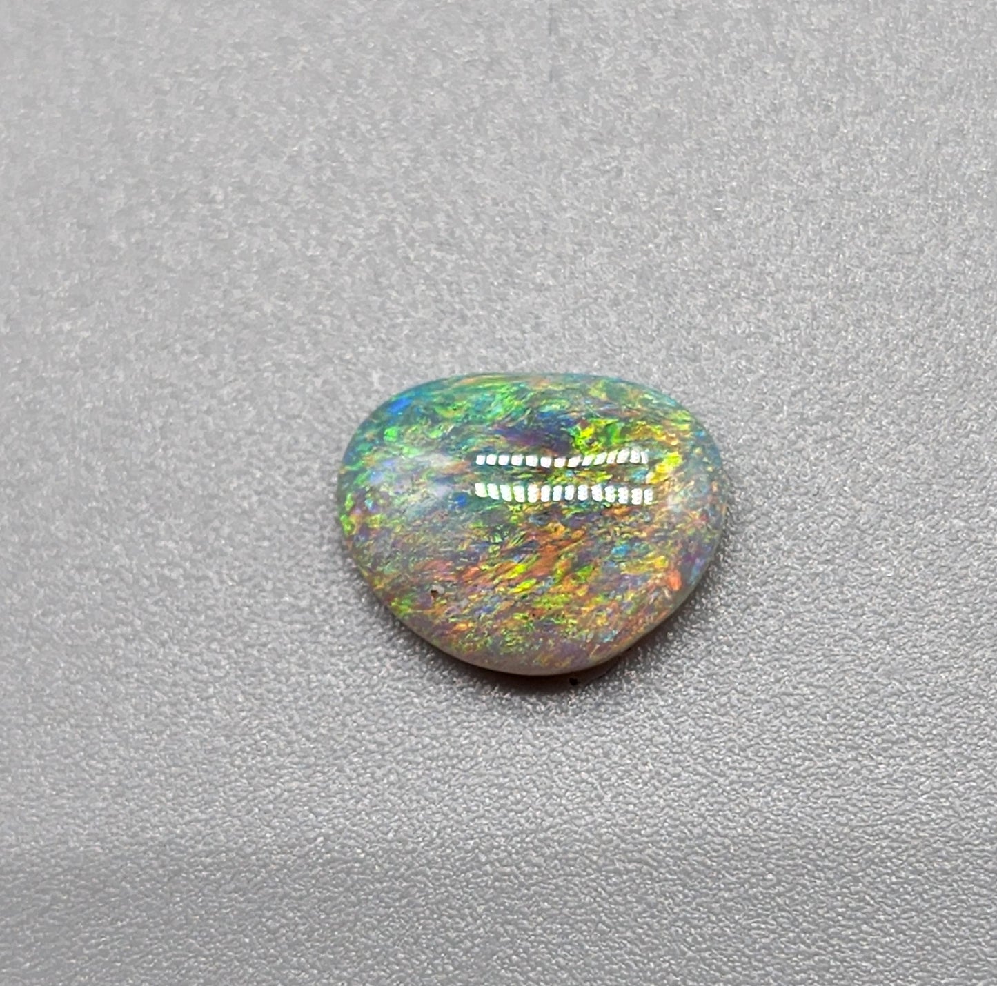 1.2cts Dark opal with a multi color pallet and feathery small flash pattern