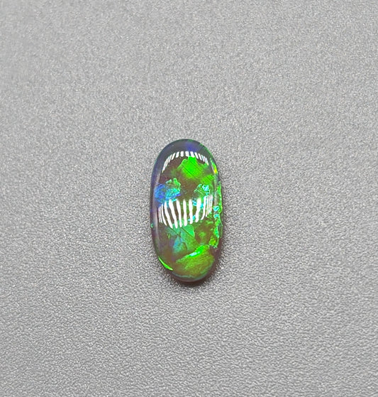 0.5ct Dark Opal with vivid green flash and hints of blue