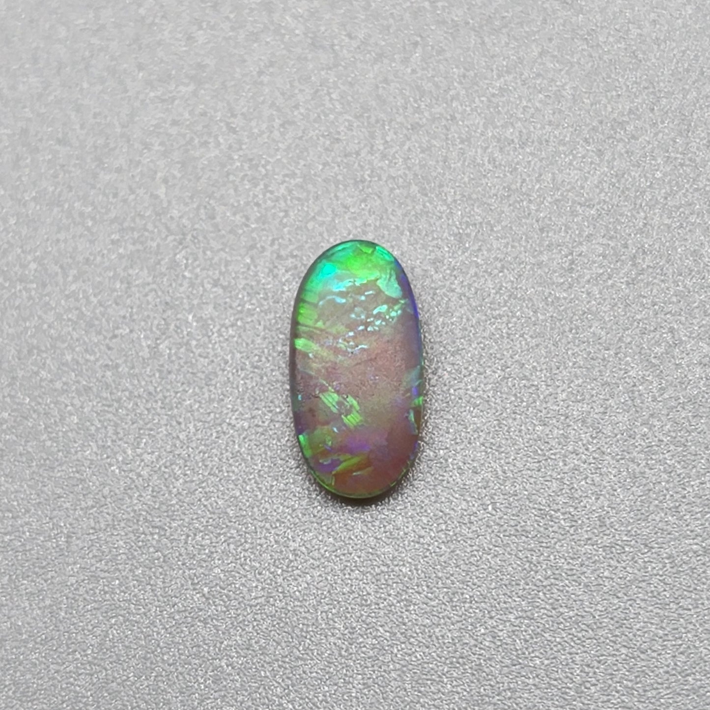 0.5ct Dark Opal with vivid green flash and hints of blue