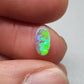 0.5ct Dark Opal with vivid green flash and hints of blue