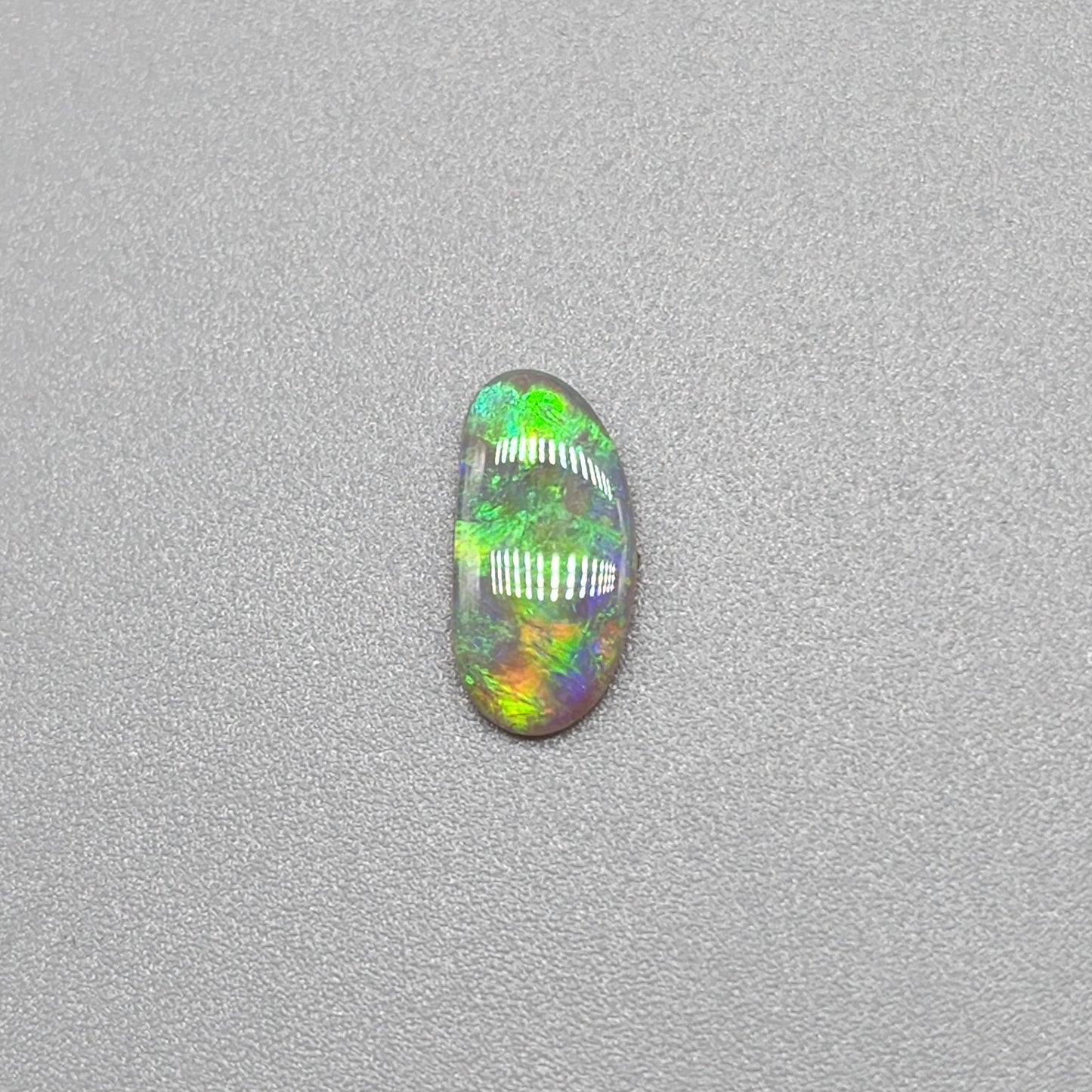 0.65ct Dark Opal with gold green color play