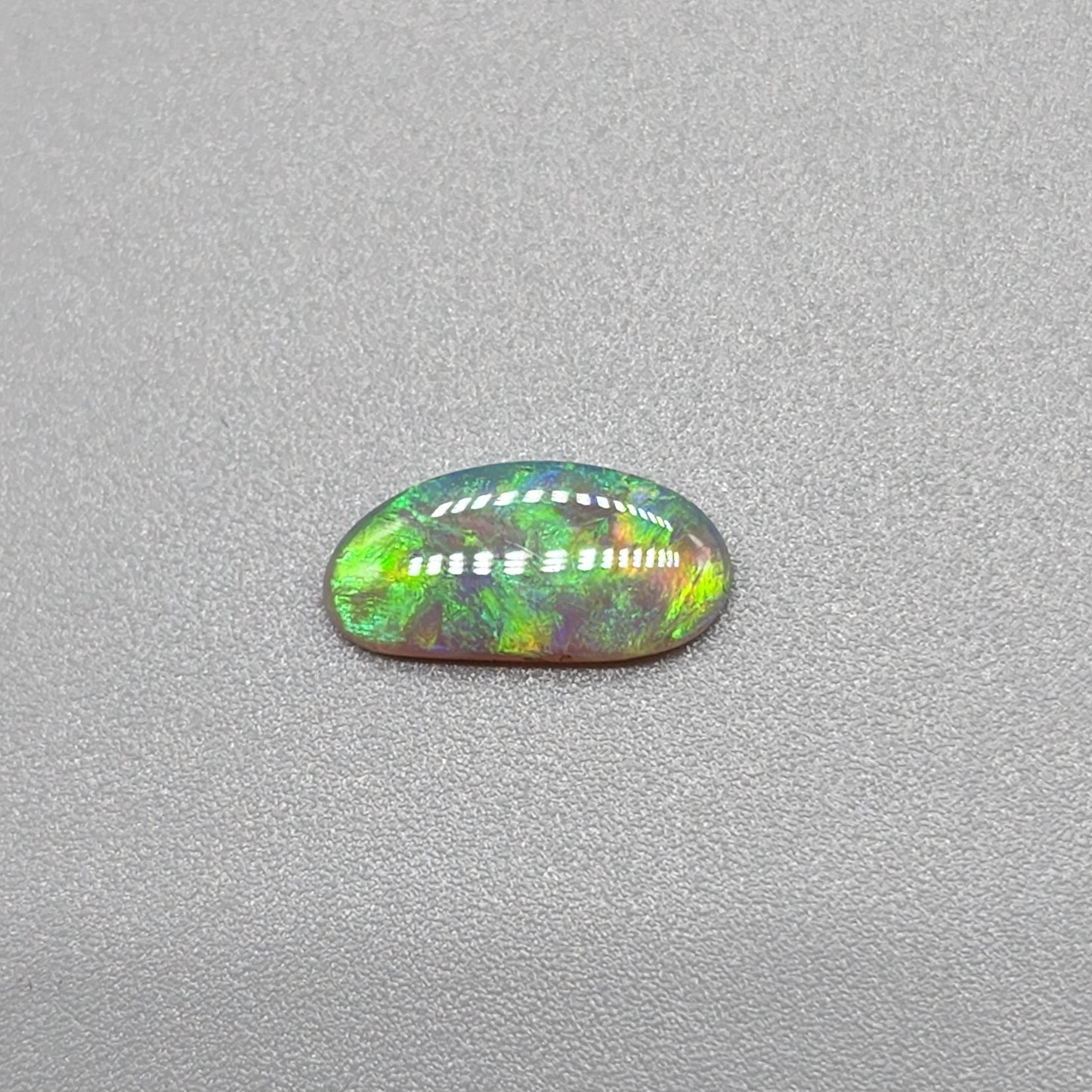 0.65ct Dark Opal with gold green color play