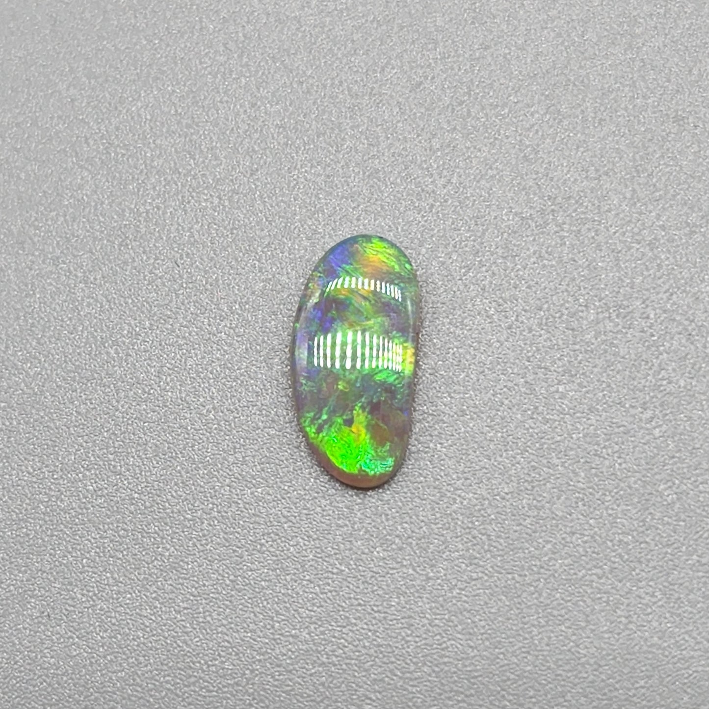 0.65ct Dark Opal with gold green color play