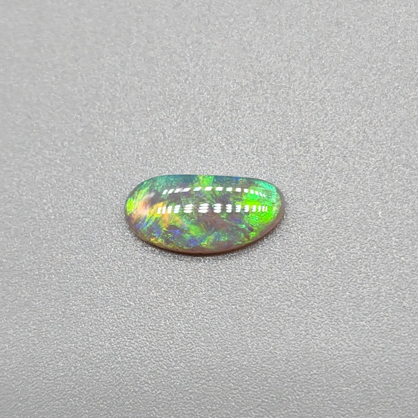 0.65ct Dark Opal with gold green color play