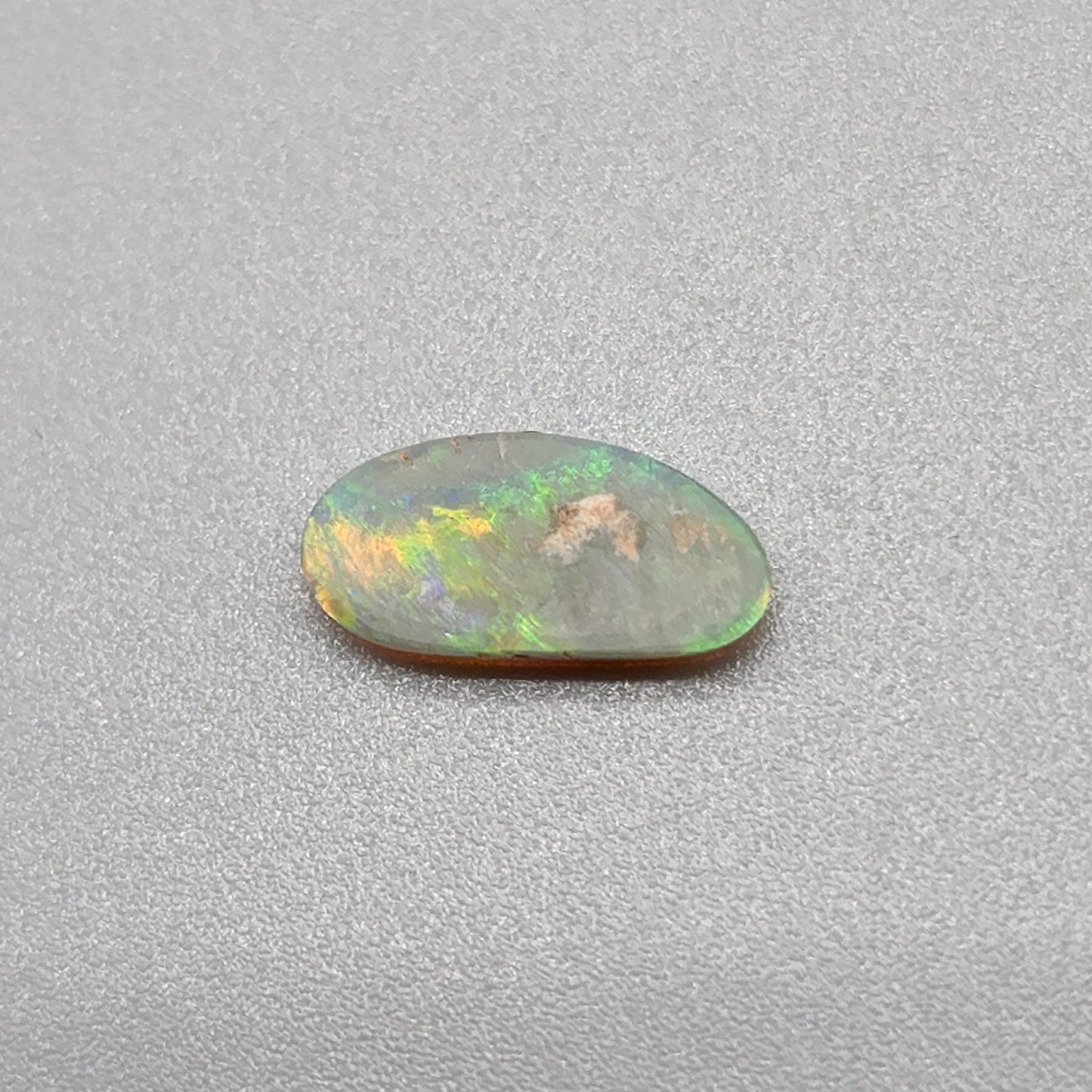 0.65ct Dark Opal with gold green color play