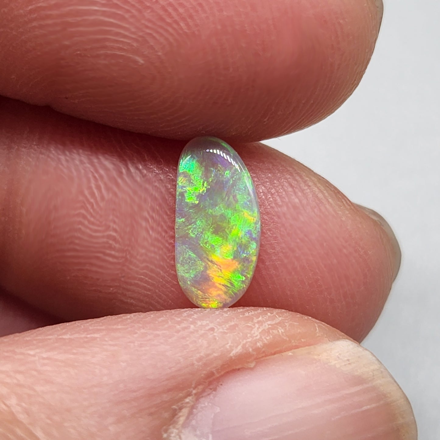 0.65ct Dark Opal with gold green color play