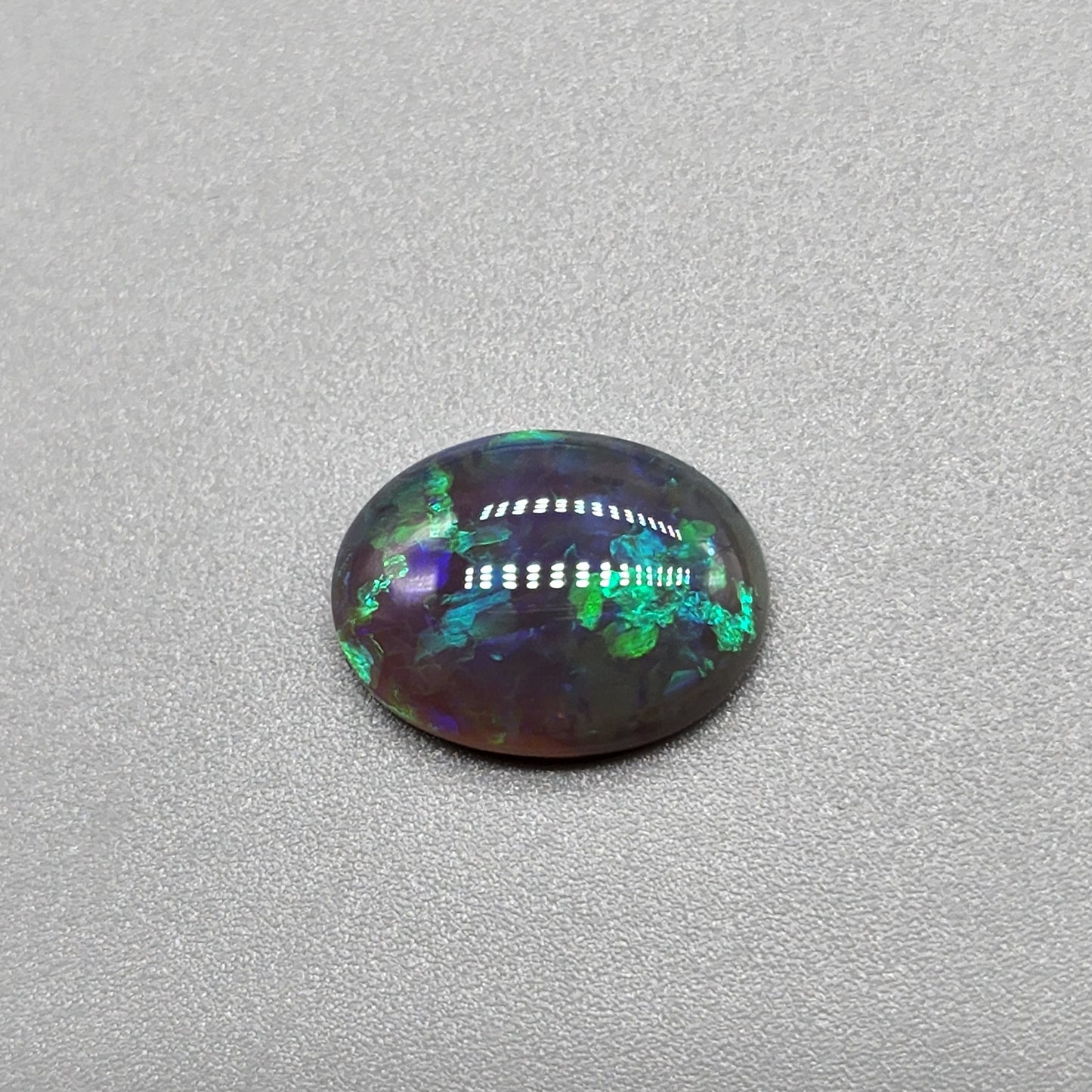 2.9cts Black Opal with organic green patterning and hints of blue.