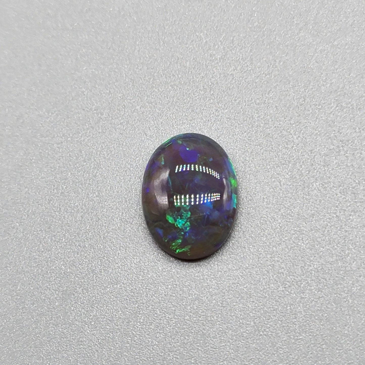 2.9cts Black Opal with organic green patterning and hints of blue.