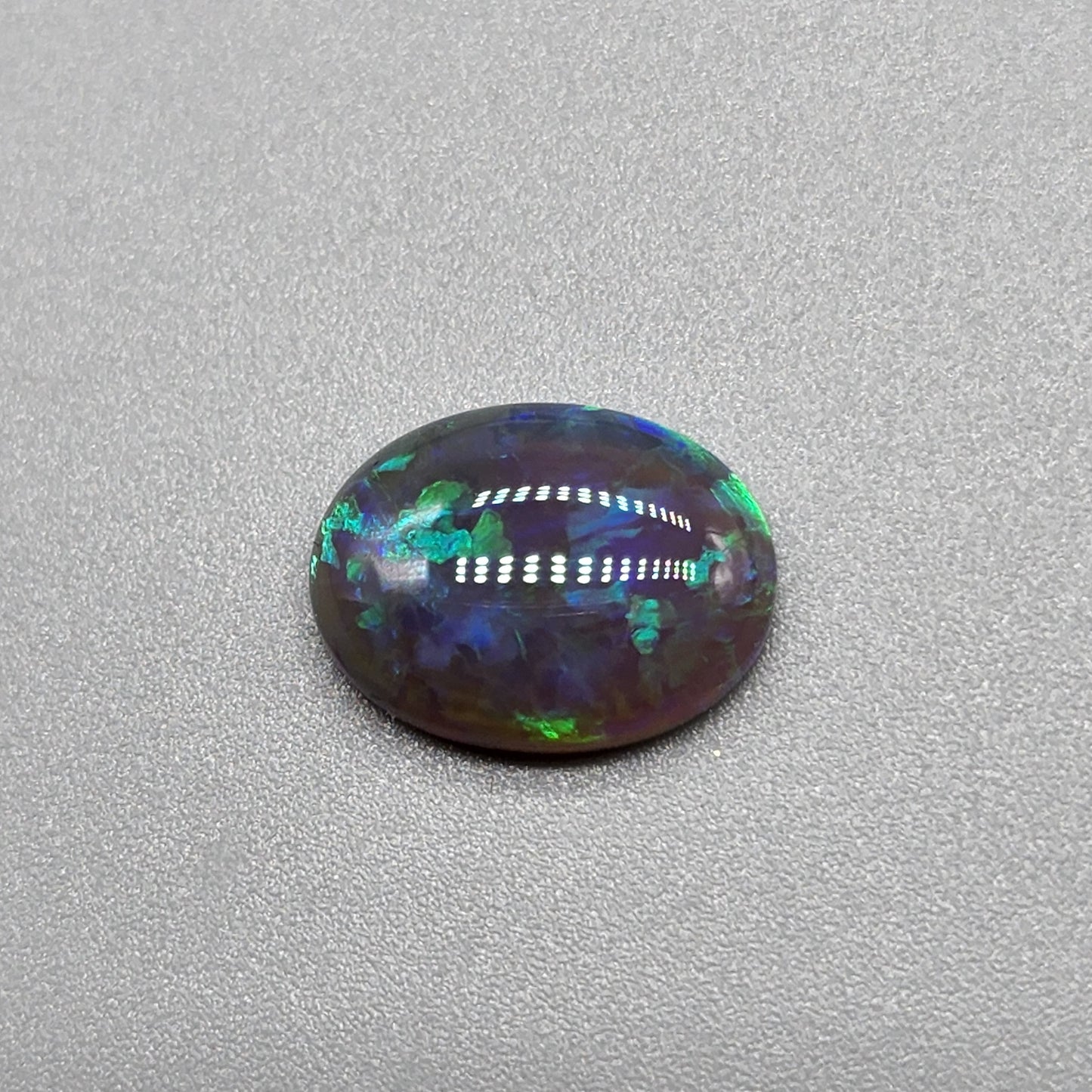 2.9cts Black Opal with organic green patterning and hints of blue.