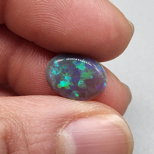 2.9cts Black Opal with organic green patterning and hints of blue.