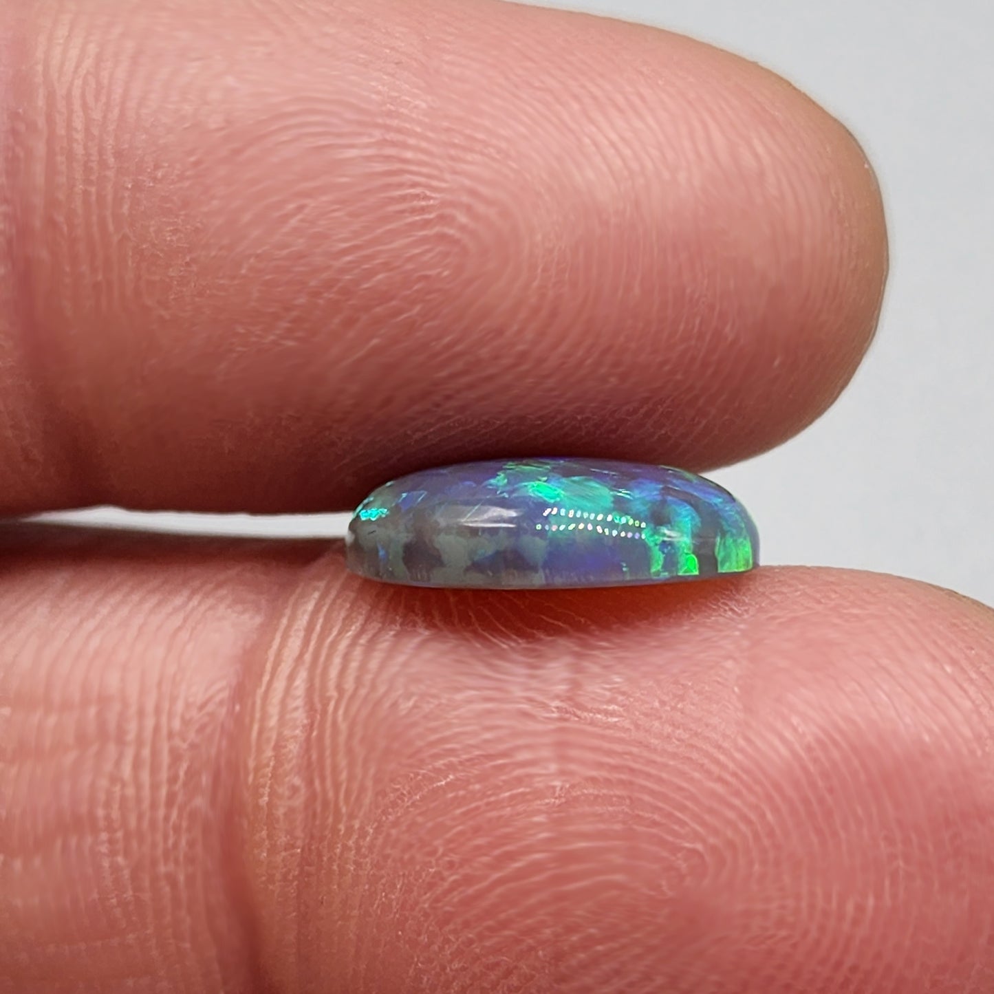 2.9cts Black Opal with organic green patterning and hints of blue.