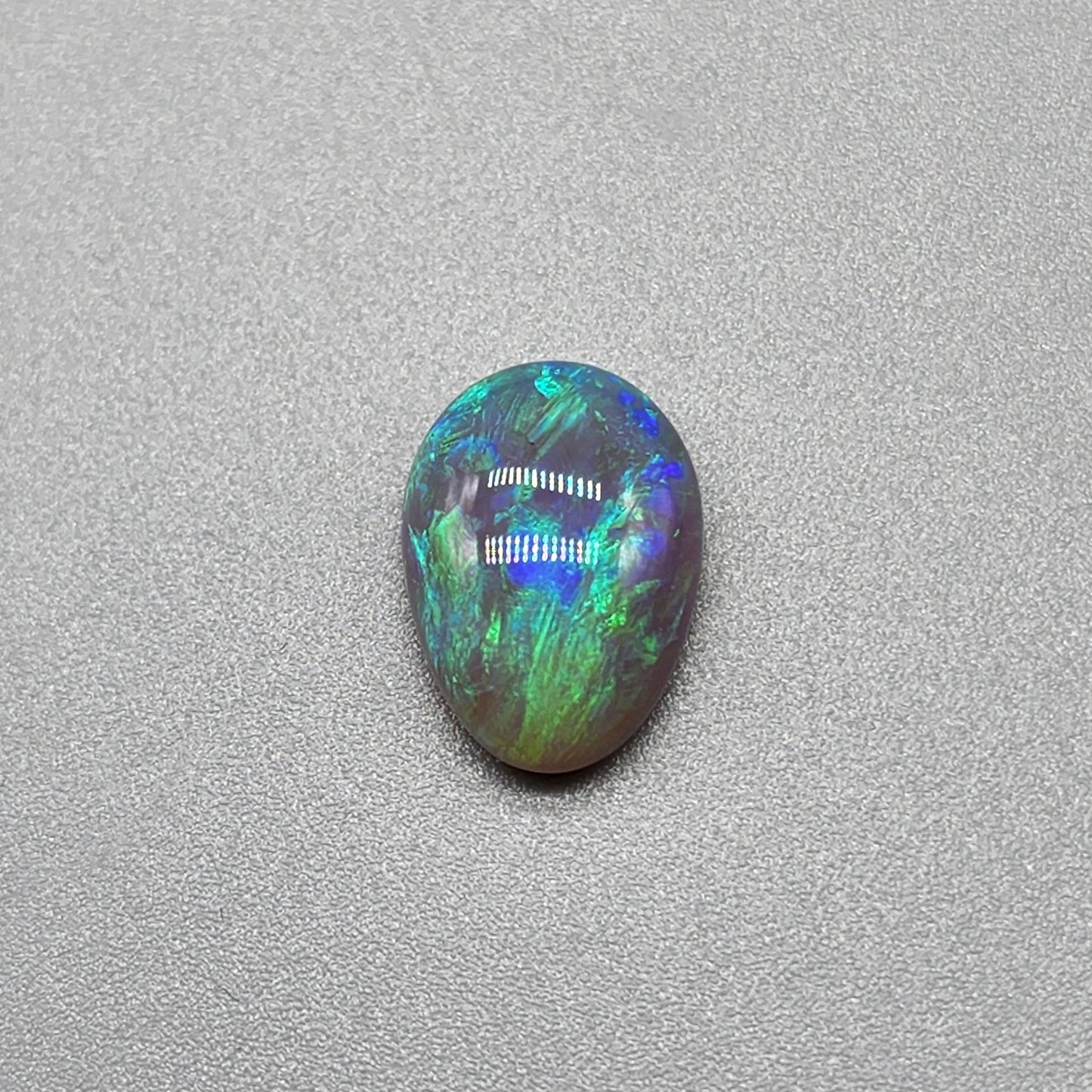 2.7cts Dark opal with bright, minty blue-green color play and well organized patterning