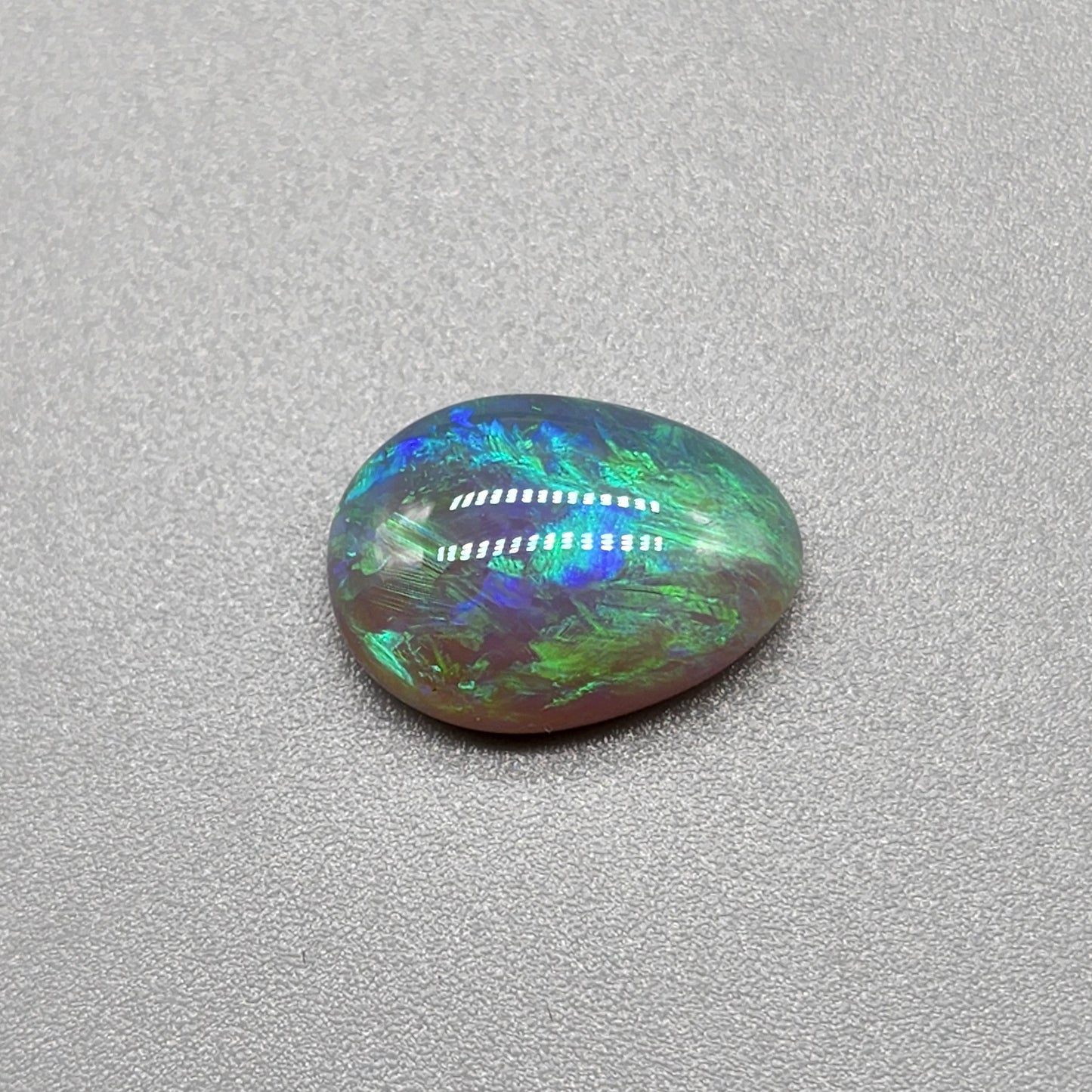 2.7cts Dark opal with bright, minty blue-green color play and well organized patterning