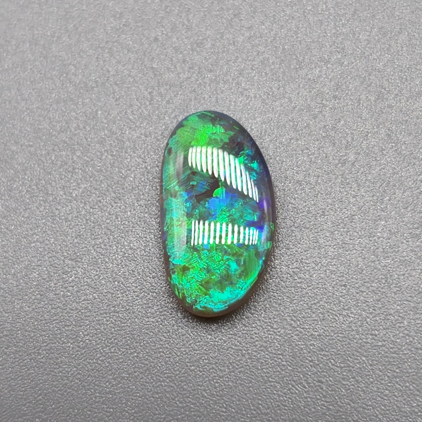 1.1cts Dark opal with vivid multi tone Green flash