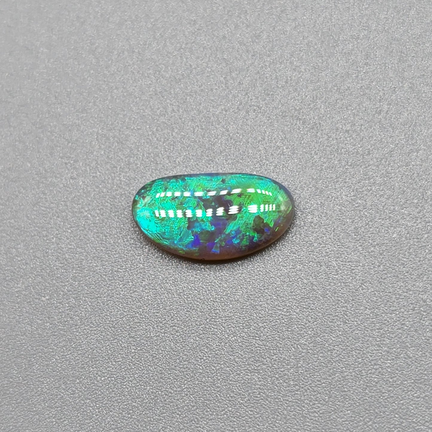 1.1cts Dark opal with vivid multi tone Green flash