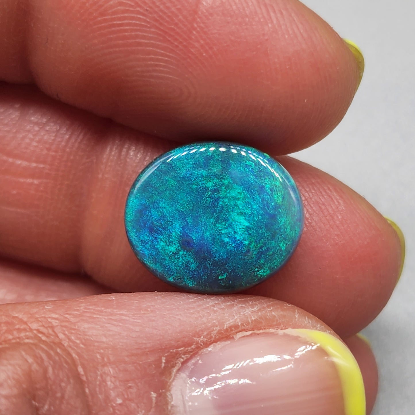 5cts Black Opal with a blue/green color pallet and galaxy pattern.