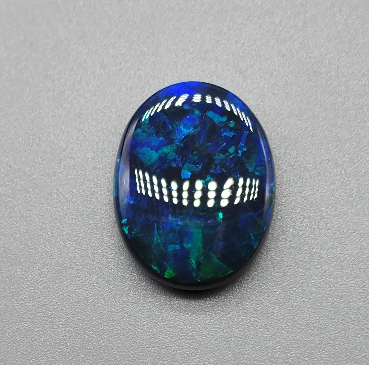 9.9cts  large Black Opal with dark earthy blues and greens and a pitch black body tone of n1-2