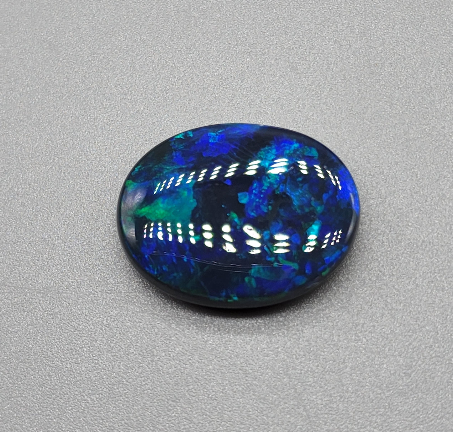 9.9cts  large Black Opal with dark earthy blues and greens and a pitch black body tone of n1-2