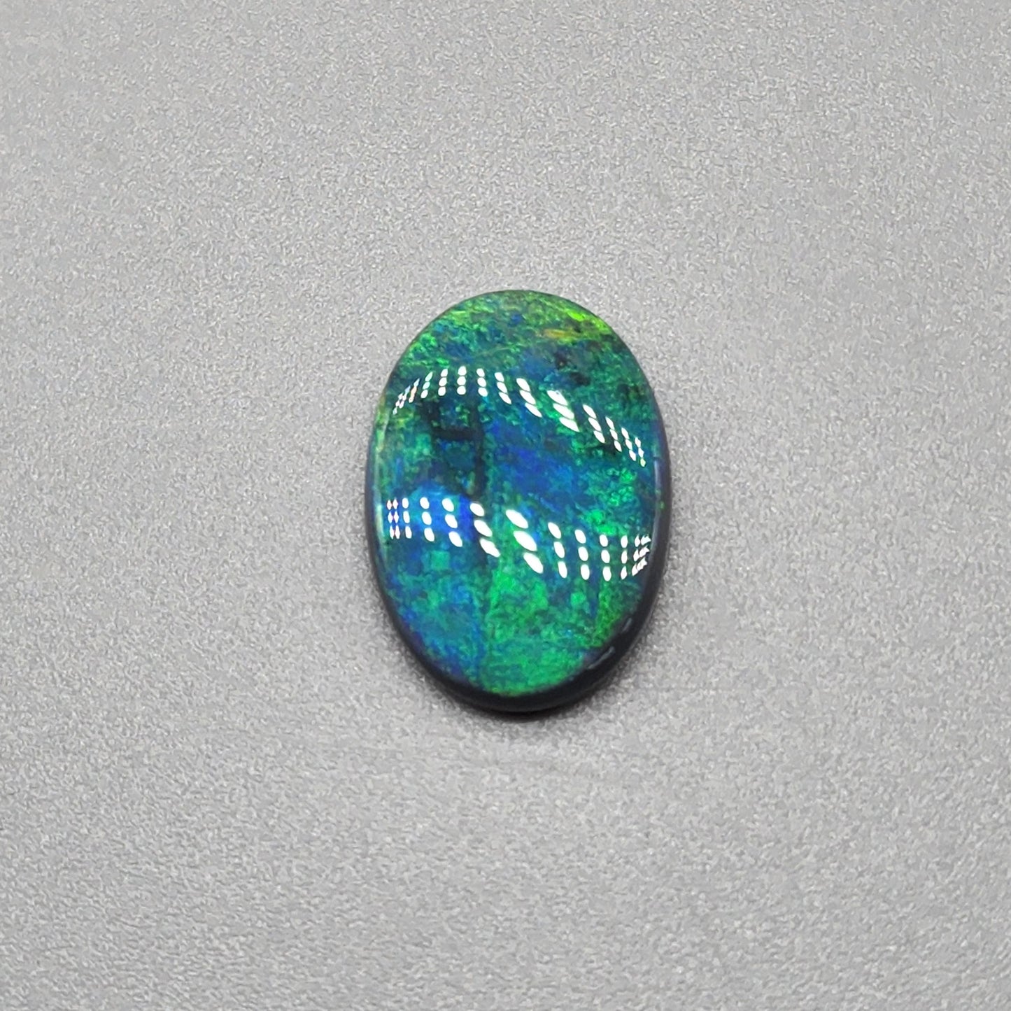 4cts Black Opal with a very Earth like color pallet, small soft patterns with vivid saturation