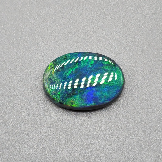 4cts Black Opal with a very Earth like color pallet, small soft patterns with vivid saturation