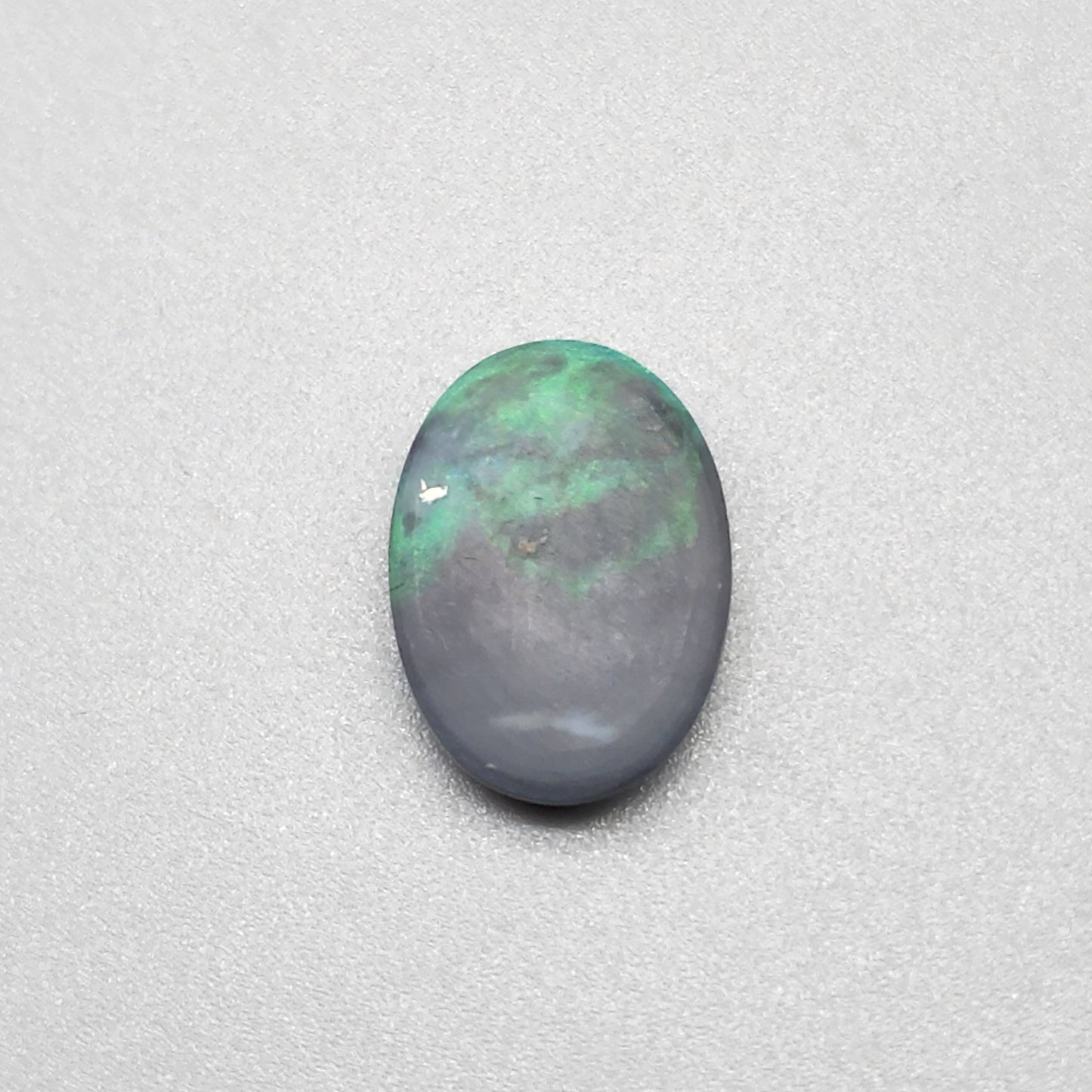 4cts Black Opal with a very Earth like color pallet, small soft patterns with vivid saturation