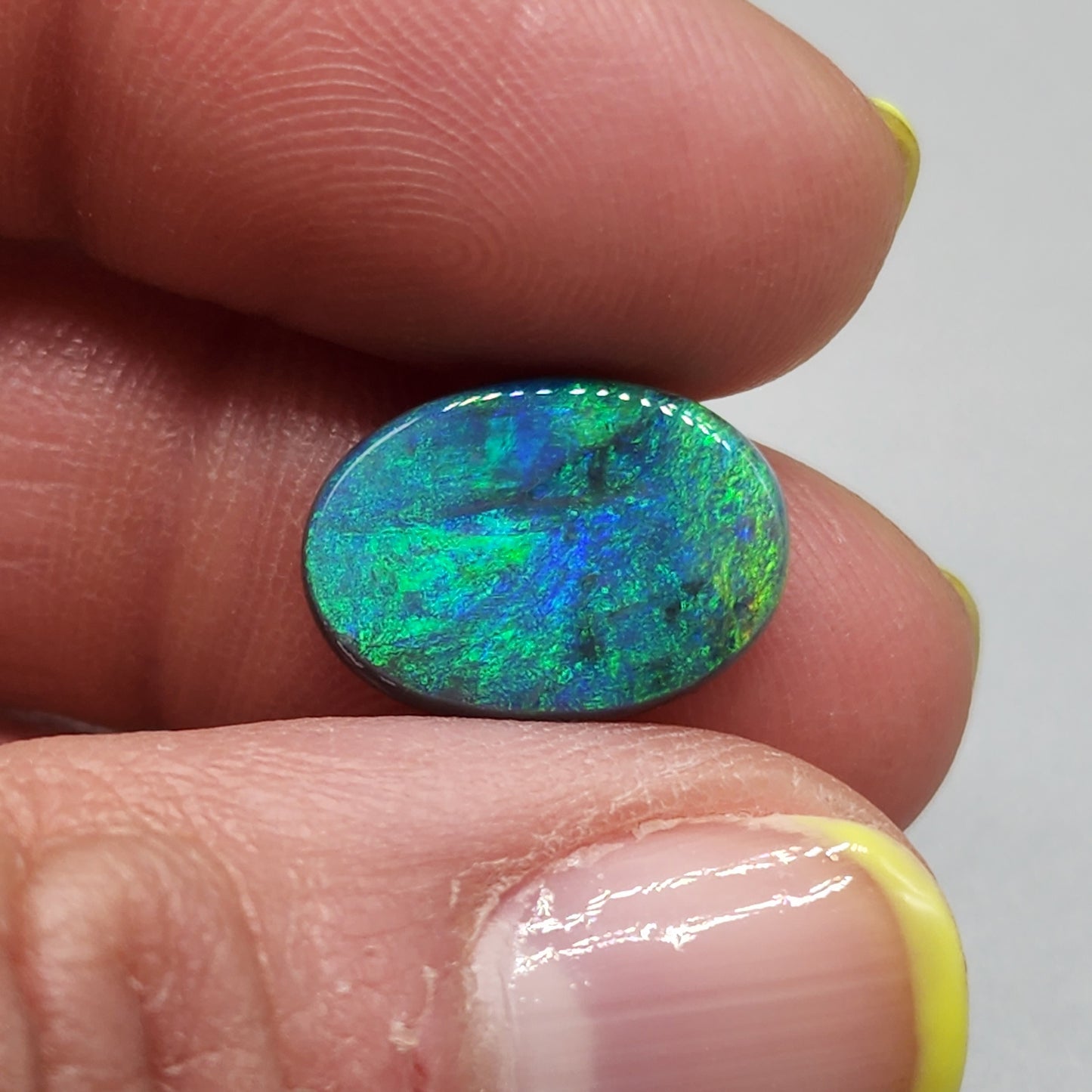 4cts Black Opal with a very Earth like color pallet, small soft patterns with vivid saturation